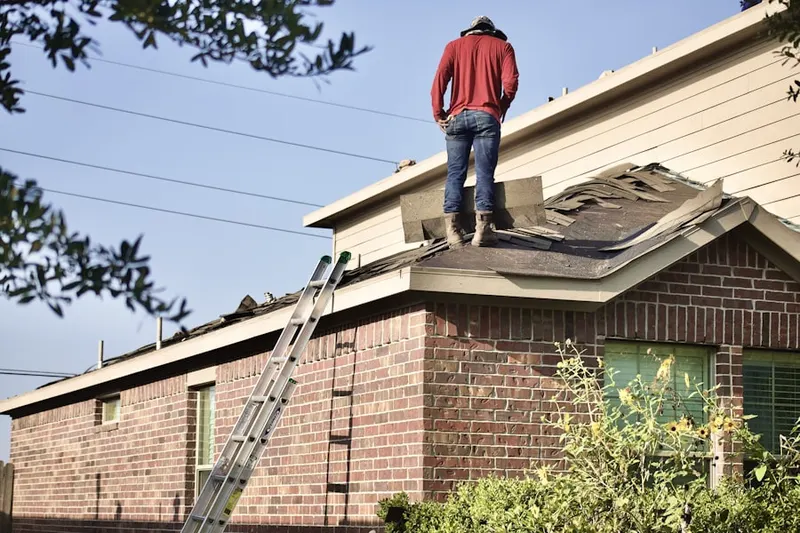 Professional roofer working on a residential roof in East Norwich